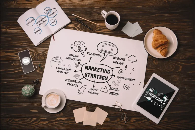 a table with a paper and coffee cups and a croissant